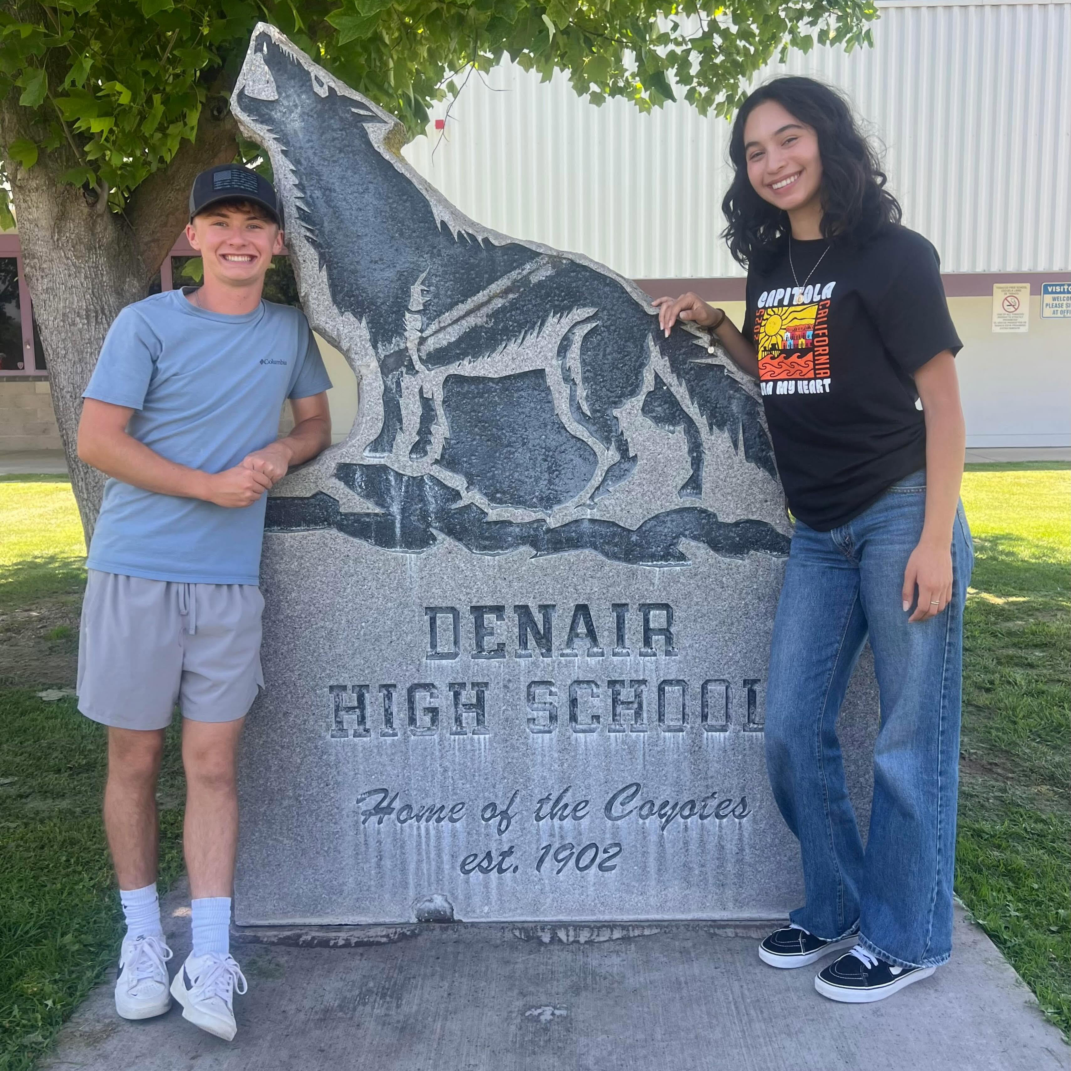 teacher and student standing in front of denair high school plaque